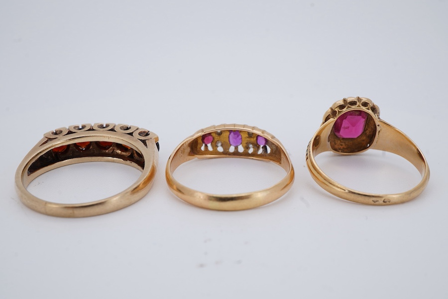 Three rings, comprising: a synthetic ruby and split seed pearl ring, the band applied with stripes of black enamel, mounted in gold, size N1/2, French assay mark for 18ct gold, French maker's mark, gross weight 3 grams,